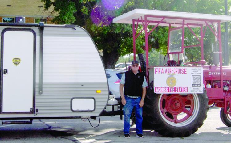 Traveling from Canada to Mexico on a 1940 Farmall M tractor Mark Koehn stopped briefly in Columbus. This marks the halfway point in his 2,000 mile trip.