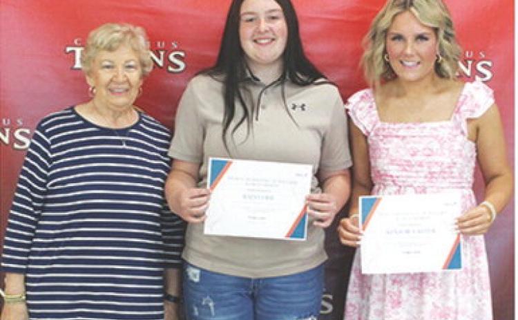 Kadi Cobb and Kenadie Carter received the Mercy Hospital Auxiliary Scholarship in the amount of $300 each from Lucille McNemar during the 2025 Senior Assembly, May 16, at the Columbus Unified High School Gymnasium.