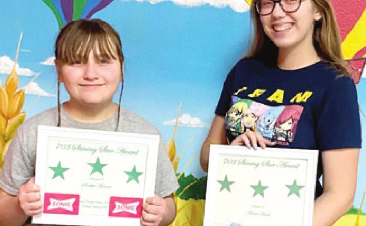 Shining Star Awards were presented to Girl Scouts Sookie Manar from Baxter Springs and Anna Head from Columbus. The Girl Scout Shining Star Award is a Service Unit award who have assisted a troop or Service Unit. Both girls received their certificates at a recent troop bowling event. Courtesy photo.