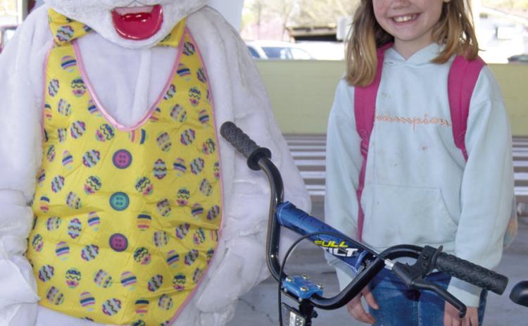 The grand prize winner in the eight to ten age division Jewelie Shrater was presented a new bicycle by the Easter Bunny Saturday morning at the Columbus Chamber of Commerce Easter Egg Hunt.