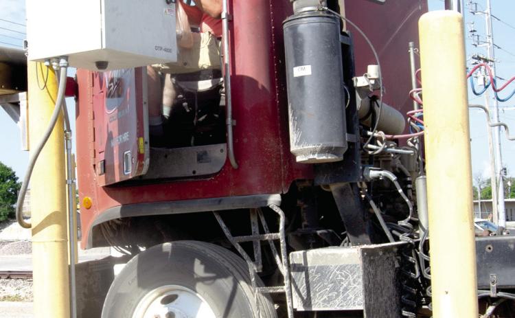 After unloading grain Craig Stover stops at the scale and place his order to take back to the fields and the other workers.