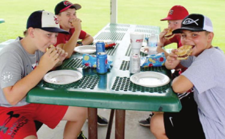 Participating in a cornhole tournament makes players hungry. Baxter Springs American Legion Auxiliary members made sure Cole Parrish, Riley Daniel, Logan Abbott and Grady Roller didn’t leave with an empty stomach. The tournament, sponsored by the American Legion Auxiliary was held Saturday in Kiwanis Park in Baxter Springs. Photo by Dee Riley.