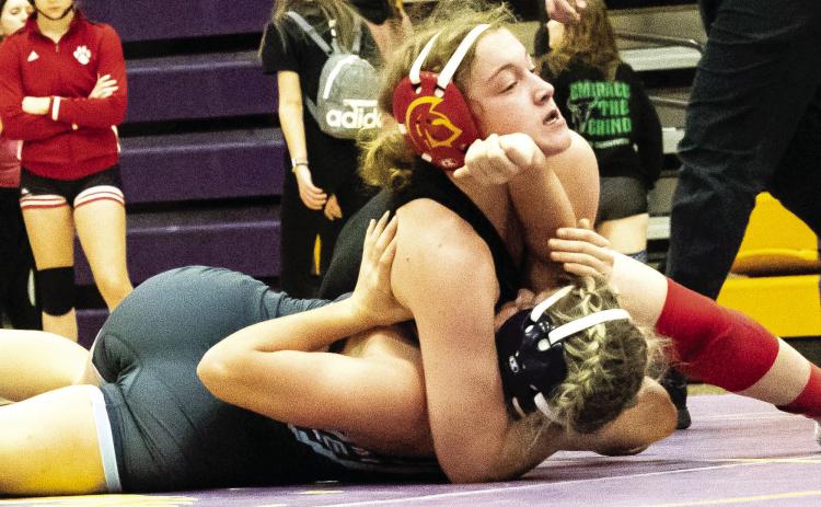 Lady Titan Senior, Addison Saporito, works for one of her four pins in the Kansas Class 4-3-2-1A Regional Championship Tournament, Saturday in Coffeyville. Addison claimed the 120-pound Regional Champion Title and advances to the state tournament, February 22-23, in Salina. Courtesy Photo.