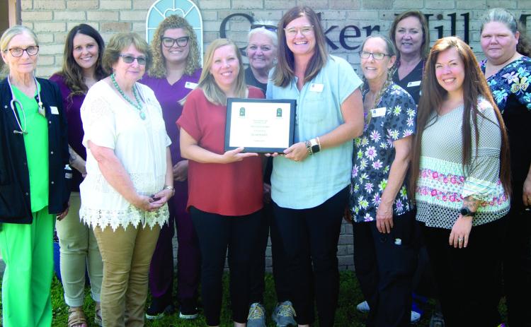 Quaker Hill Manor recently received an award for transitioning to gold status. Those accepting the award included front row Debbie Hopkins, Amy Bailey, Mandy Kinsley, Karen Stockton, Rhonda McDonald. Back row Susie Reed, Goldie Hubbs, Marissa Shaurette, Jan Edwards, Liz Schoenfeld, Rhonda Carter.
