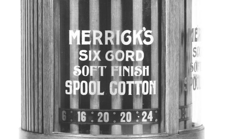 Miniature chest holding spools of thread sat on counter in country store