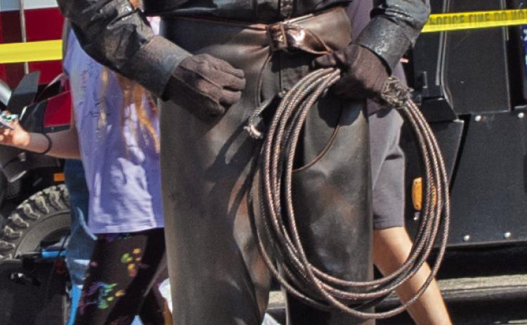 One of the entertainers at the Columbus Day Festival was a human statue. He was dressed as a bronze cowboy sculpture. Photo by Neva Hiatt.