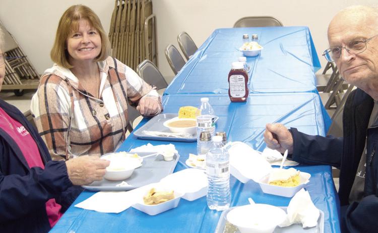 Clara White, Ralph White, and Regina Jameson enjoying lunch at the Columbus Lions Club Bean and Soup feed held March 5 at the St. Rose Parish Hall.