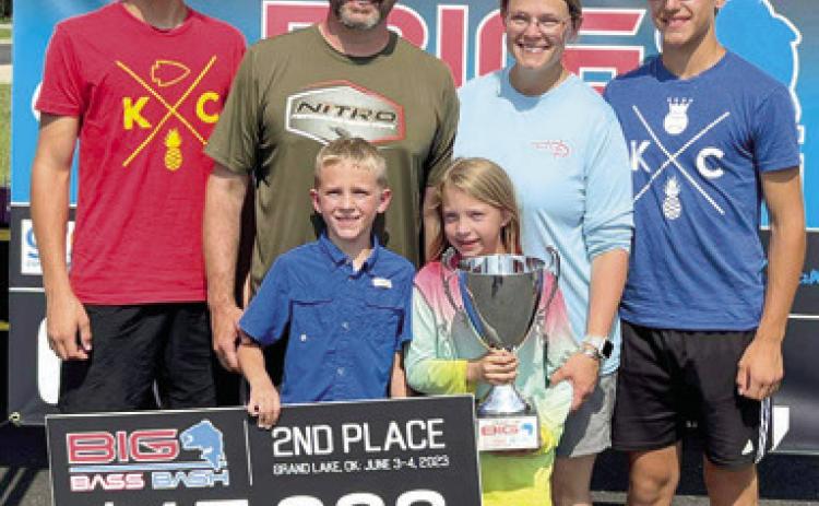 Fierce competition and a last minute weigh-in brought a second place finish for Gunnar Wixon of Baxter Springs at the Big Bass Bash in Grove, Okla. Wixon had been in the lead with his 6.53 pound catch up until the last few minutes when Joe Waggoner of Carl Junction, Mo., weighed in his 6.65 pound bass. Wixon’s family joined him for the presentation. Courtesy photo.