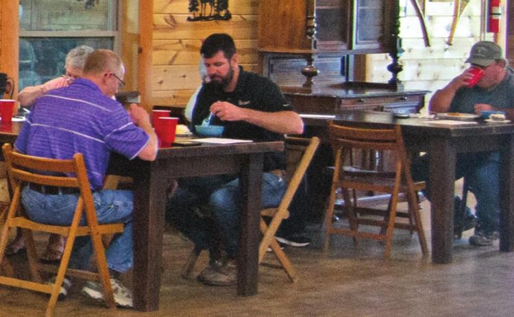 Representatives from Columbus-based community businesses and organizations met at Rowdy’s Rustic Moose Lodge for their monthly Chamber meeting. Dale Helwig from the K-State Research and Extension Office, Mike Evans from Liberty Utilities and David Holmes from Torchia-Holmes Real Estate all enjoyed a lunch prior to the meeting beginning. Photo by Jacob Spencer.