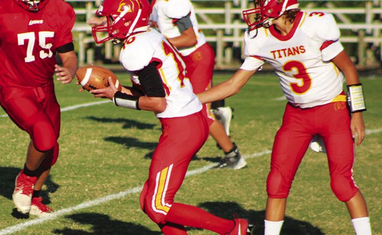 Titan Eighth Grade Quarterback, Cole Howard, hands off to running back/wide receiver, Brody Carter, for a nice gain in the Thursday game at Baxter Springs. Howard scored two rushing touchdowns and hit Carter for a touchdown pass play in the 22-20 win over their host.