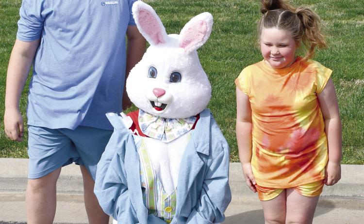 Visiting with the Easter Bunny Corbin and Chole Lake were among the hundreds of youngsters at the Baxter Springs High School. The hunt is sponsored by the Baxter Springs Kiwanis Club. The event was held Saturday at the Junior High and High School complex. Photo by Greg Hiatt.