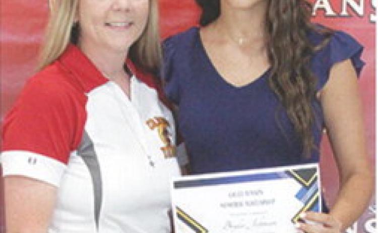 Brylie Johnson received the Callie Henson Memorial Scholarship in the amount of $500 from Ryan Lacen during the 2025 Senior Assembly at the CUHS Gymnasium, May 16.