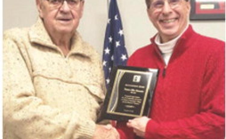 Dr. Mark Watkins, the President of Labette Community College (LCC), presented an appreciation plaque to Mike Howerter for his years of service and leadership to LCC and the Board of Trustees. Howerter served as a LCC Board of Trustees member from 2015 to 2024. Courtesy photo.