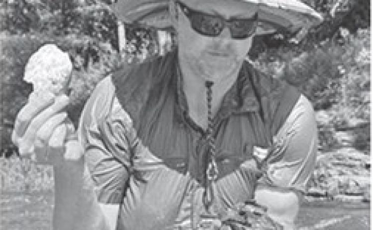 Pittsburg State University biologist James Whitney finds a dead mussel’s shell while sifting through rocks in the Spring River. Celia Llopis-Jepsen/ Kansas News Service