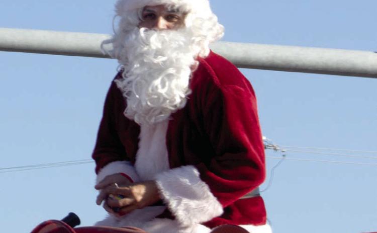 Santa once again was atop the Baxter Springs fire truck to close the Baxter Springs Christmas parade. The near perfect weather led to a large crowd and much candy for the youngsters.