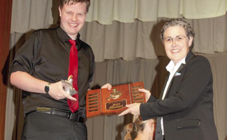 Carson Cobb received the Louis Armstrong Jazz award from Columbus High School band director Gae Phillips at the spring concert.