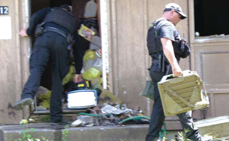 Two members of the Kansas Highway Patrol EOD (explosive ordinance disposal) bomb squad exited the building carrying the suspicious box. They took the box to the cemetery where it was opened and “viable pipe bomb,” however it had no more explosive power than a shotgun shell.