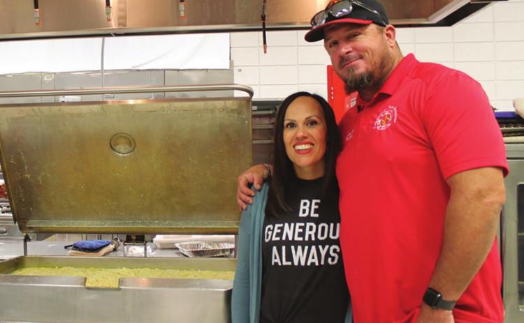 Leslie Minor and her husband, Columbus Firefighter, James Minor, help serve Chicken and Noodles at the Malachi Brown fundraiser in Baxter Springs. Over 700 meals were served.