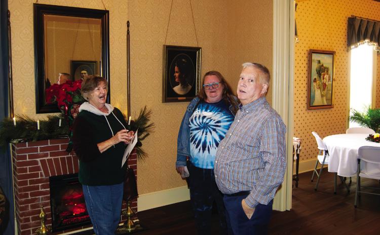 Geoffrey “Casey” Roberts acts as a tour guide for the visitors at the Rial A. Niles House open house Saturday afternoon. The fund raiser for the Baxter Springs P.E.O. Scholarship fund. The 1870 showplace has been completely remodeled back to it’s original style.