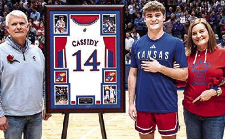 Patrick Cassidy and his parents Jeff and Julie Cassidy during the Kansas University Senior Night Ceremonies, Tuesday, at Allen Fieldhouse in Lawrence. The academic senior will use his available eligibility to continue his career with the Jayhawks next season. (Courtesy Photo.)