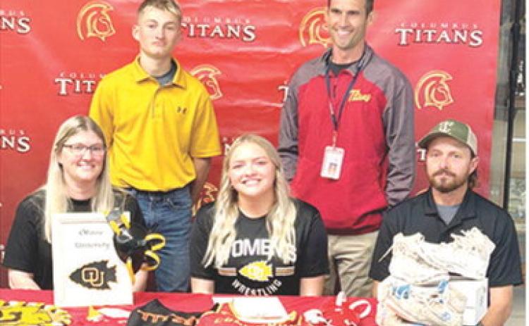 Lady Titan Senior, Emily Britt, signed a National Letter of Intent to continue her wrestling career with the Ottawa Lady Braves this fall. Emily was joined by her parents, Kimberly and Carl Britt and brother Carlson and Titan Head Wrestling Coach Marcus Bowman at her signing ceremony, Wednesday, at the Columbus Unified High School Gymnasium. Courtesy photo.