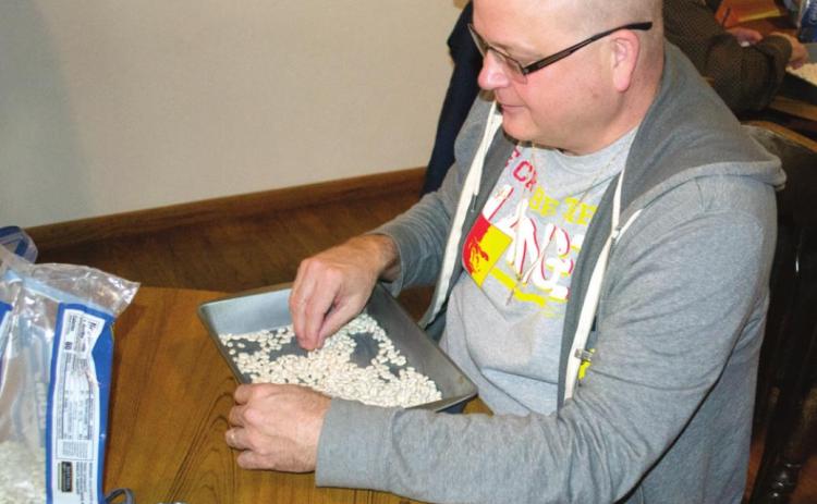 Lions Club member Steve Jameson was helping sort and clean the beans for the annual bean feed scheduled Thursday, March 4.