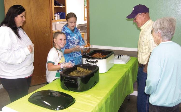 Members of the Cherokee County 4-H Clubs held a spaghetti lunch to raise funds for improvements to their local building. The youth helped prepare and serve the lunch to area diners. Keith and Helen Kelly were among the diners supporting area youth.
