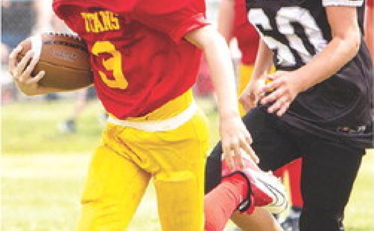 Columbus Mini Titan, Bodie Saiz, broke tackles as he scored the final touchdown of the third and fourth grade Titan win over Frontenac, 30-0, at Titan Stadium, Saturday. Photo courtesy Kristin Sharp.