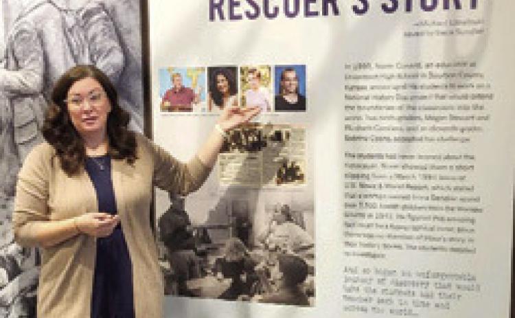 Megan Stewart Felt, program Director of the Lowell Milken Center for Unsung Heroes in Fort Scott shows the Sheridan Homemakers a panel from the Irena Sendler exhibit. Felt was one of three Uniontown students who discovered Sendler’s story. Photo courtesy of Evon Goettel.