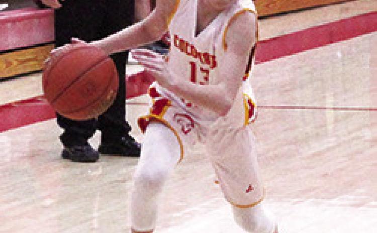 Titan Eighth Grader, Carter Woodcock, drives to the basket in games with Baxter Springs, in January, at the Central School Gymnasium.