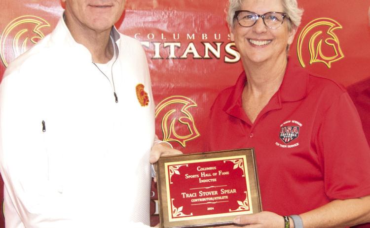 Presenting the plaque to inductee Traci Stover Spear, was Columbus Hall of Fame chairman Kerry Sachetta.