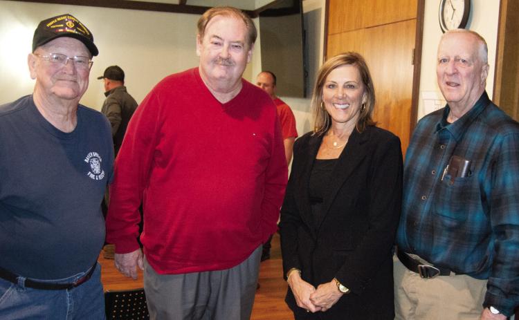 Two long time fire fighters (left) Wayne Cook and Les Page surround Tim Shallenbuger and City Treasurer DeeAnn Auman-Hill. Shallenburger and Hill worked tirelessly on procuring the funding for the new building.