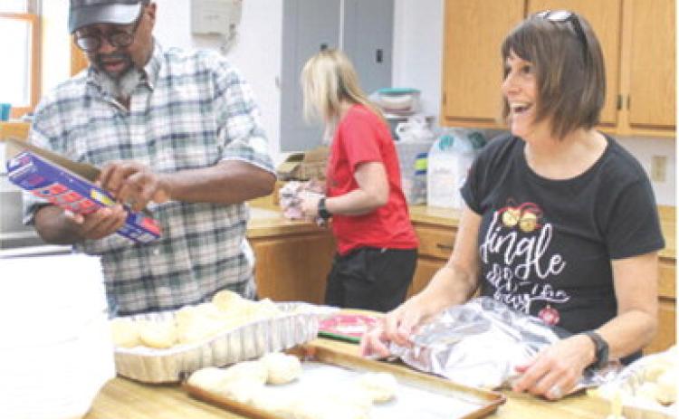 Bill Jones and Susan Shultz were among the volunteers preparing the meal for the Community Christmas dinner Saturday.