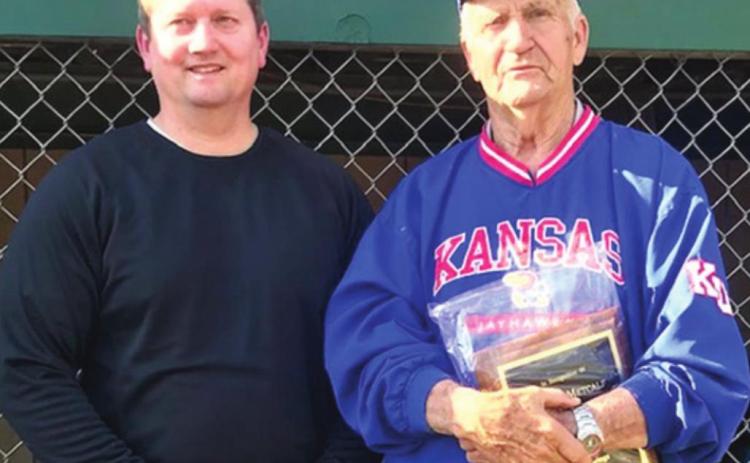 Wayne Metcalf was presented a plaque by Baxter Springs Little League President, Bill Buck, during opening ceremonies recognizing the long time volunteer for his 55 years of service to the league and community. A new scoreboard was erected to officially renamed the local field as Wayne Metcalf Field. Photo by Dee Riley.