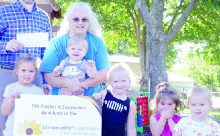 Making a Difference in Childcare grants have been awarded to four Cherokee County Daycares by The Community Foundation of Southeast Kansas (CFSEK). Donna Poor with Kiddie Garden Day Care in West Mineral will be using their grant for outdoor equipment. Devin Gorman with CFSEK presented the check. Courtesy photo.