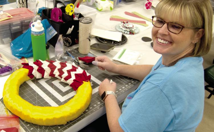 One unusual craft at the St. Bridget’s Scrapbook seminar is making colorful wreaths, Kristi Finther, Pittsburg is attaching material to a straw wreath to make a flag wreath. There are a number of different crafts in process during the two day event.