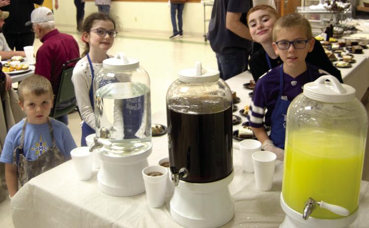 All hands are on deck when serving the annual Knights of Columbus Fish Fry in Scammon. Even the youngsters volunteer to help. Andrew Holden, Zoe Friemel, Zane Friemel and Jacob Friemel assisted at the beverage table.