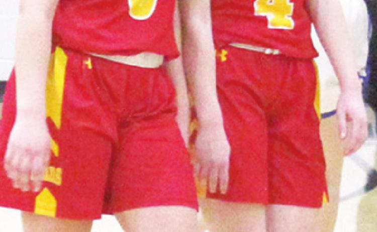 Sisters Katy Mooney, freshman and Lily Mooney, senior, walk off the court for the last time as teammates after the heartbreaking Lady Titan Sub-State loss to Neodesha, 47-52, Saturday in Fredonia.