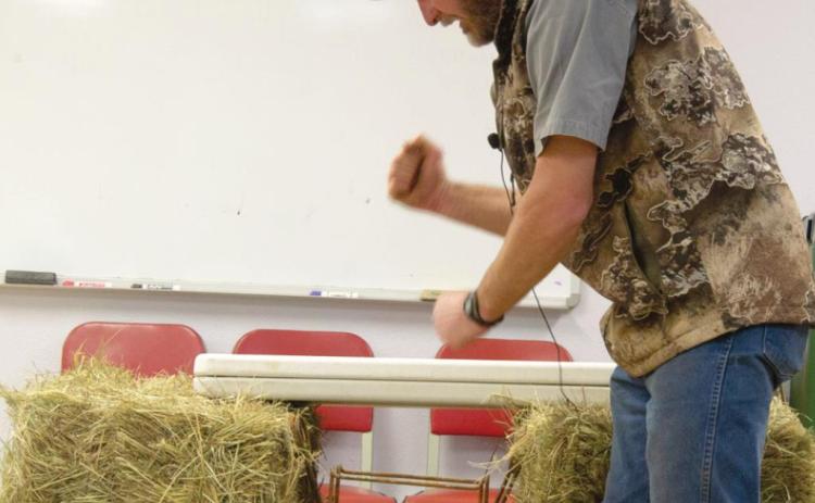 KSU Wildlife Specialist Drew Ricketts was at the Cherokee County Research and Extension Office in Columbus for a beaver trapping workshop March 4. Attendees are shown how Ricketts sets his own traps in the openings of beaver dens. Photo by Jacob Spencer.