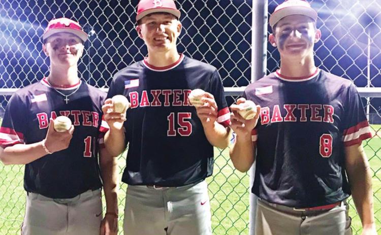 Baxter Springs Lions hitters, Kameron Williamson, Riley Bush and Kaden Niday display their home run balls, a grand slam for Niday, as the Lions clinch the CNC League Title with a sweep of the Bulldogs, 22-5 and 11-3, in Galena, Thursday Night. Photo by Dee Riley.