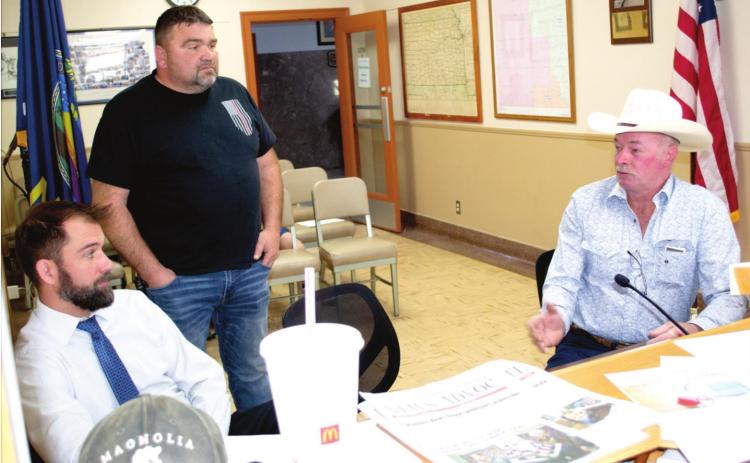 Addressing the Cherokee County Commission Royce Cantrell (right) sought help from the commissioners in a sewerage problem in the city of Galena. County Counselor Nathan Coleman (left) and Jason Allison County Emergency Management Director listen to Cantrell�s discussion with the commission.