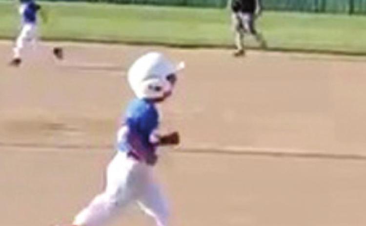 Five year-old Kason Pitts runs to first base after hitting a hard ground ball at the Field of Dreams in Baxter Springs. Photo by Dee Riley.