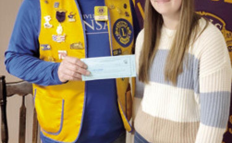 Lions Club President Mark Winter presented Lion of the Month Kennedy Bullard with a Chamber of Commerce gift certificate at a recent meeting.