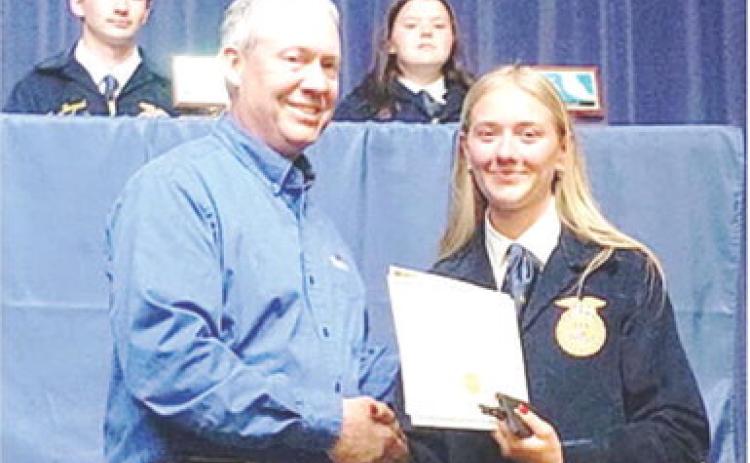 Southeast FFA senior, Kendyl Renn, was presented the FFA senior appreciation award from Dr. Kurtis Gregory, Cherokee County Farm Bureau representative at a recent ceremony. Courtesy photo.