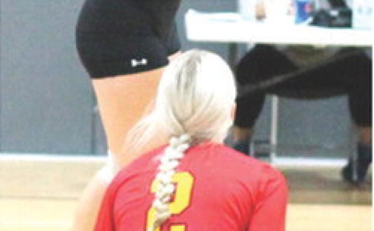 Lady Titan Senior, KT Lopp, returns the ball over the net during the bracket play game against Chanute, Saturday, at the Frontenac High School Invitational Volleyball Tournament. The Lady Titans won two matches in three sets and lost three matches in a full day of volleyball action. Columbus will have another long day on the court in annual Oswego Tournament, tomorrow, beginning at 8 a.m.