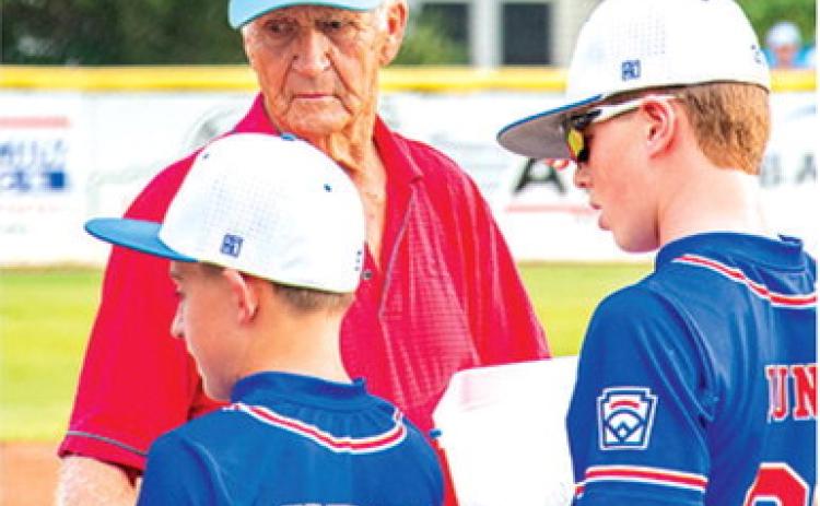 Reigning Kansas Little League Baseball District 2 Administrator, Wayne Metcalf, hands out awards to teams competing in the Kansas State Little League Championship Tournament in Baxter Springs, July 24-25. The Pittsburg JL Hutchinson League All-Stars won the 11-12 year-old division over The JOCO Navy (Royals Amateur Development System) in a close bestof- three series hosted by the Baxter Springs Little League at Wayne Metcalf Field.