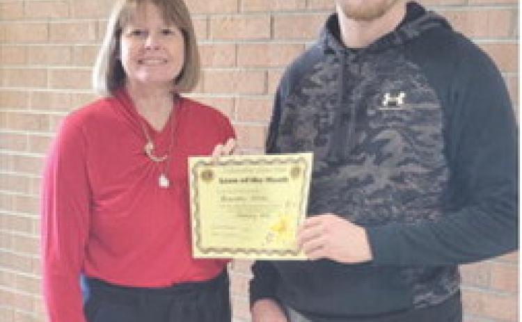 Brandon Stice was named Columbus Lion of the-Month for January. Regina Jameson is shown presenting the certificate. Courtesy photo.