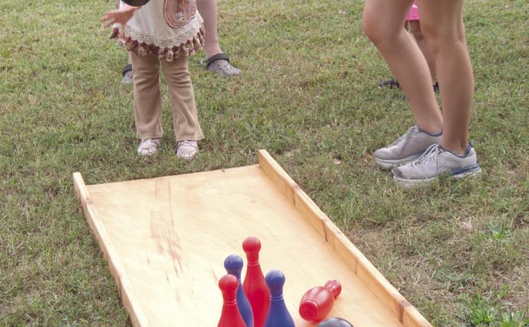 Lawn bowling can be intimidating for youngsters such as Abagale Harvey as she does her best to knock down the pins. The game was one of many games at Scammon Fall Festival.