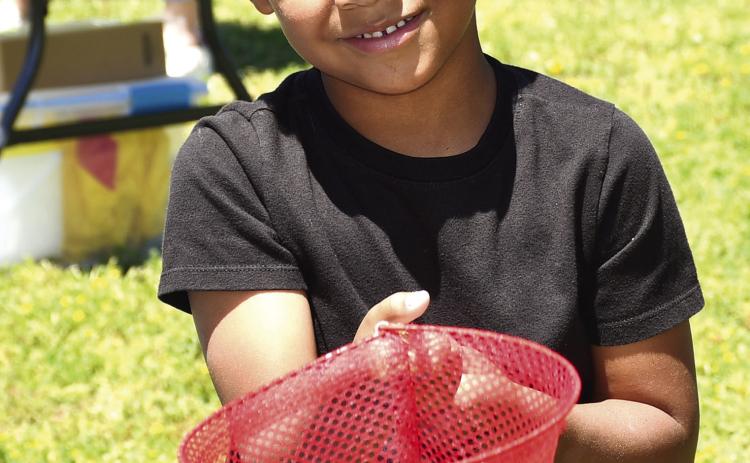 Park elementary kindergarteners celebrated the end of the school year with some last minute carnival fun. Teachers set up and launched a mini carnival at the school including multiple activities. They had a tattoo station, catch the ducks station, boardwalk game, outdoor tic tac toe, ribbon wand fun and popcorn and cotton candy. Youngsters were also given the chance to pose in the carnival photo booth. Ezequiel Lee had just tried his hand at the duck booth. Photo by Tanya Woolsey.