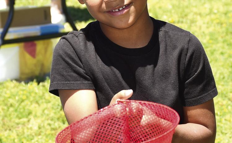 Park elementary kindergarteners celebrated the end of the school year with some last minute carnival fun. Teachers set up and launched a mini carnival at the school including multiple activities. They had a tattoo station, catch the ducks station, boardwalk game, outdoor tic tac toe, ribbon wand fun and popcorn and cotton candy. Youngsters were also given the chance to pose in the carnival photo booth. Ezequiel Lee had just tried his hand at the duck booth. Photo by Tanya Woolsey.